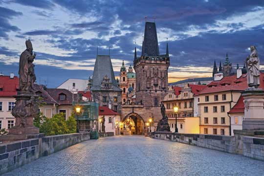 Charles Bridge in Prague evening with towers and Lesser Town