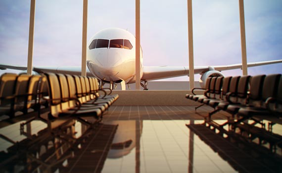 An airplane in front of a terminal at the Prague Airport